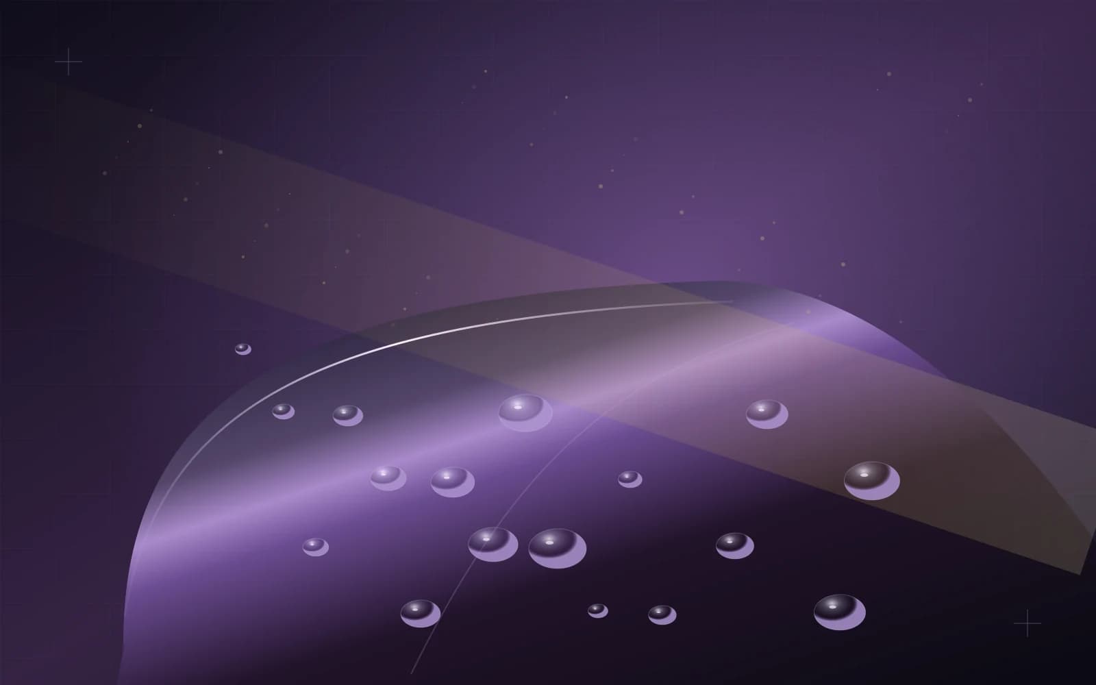Water droplets and fine dust above a purple protective surface in warm angled light
